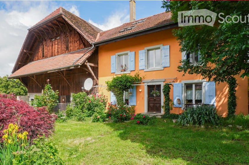 2 story house, orange exterior, wooden beams, blue shutters, garden, satellite dish