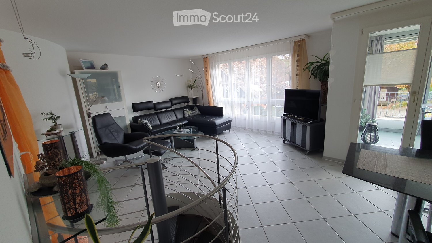 modern apartment, leather sofa, glass table, TV, spiral staircase, white tiles, plants, open balcony