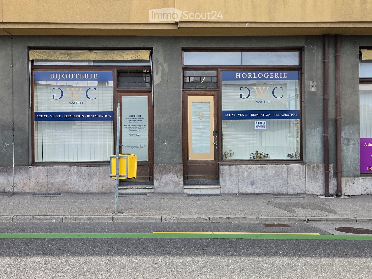 Two storefronts on a building facade, one labeled "BIJOUTERIE" and the other "HORLOGERIE" with glass windows and wooden doors.