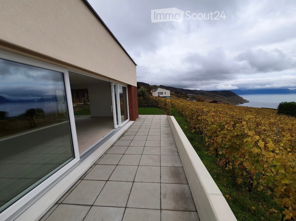 Balcony with tiled floor, large glass sliding doors, overlooking vineyard and sea view.