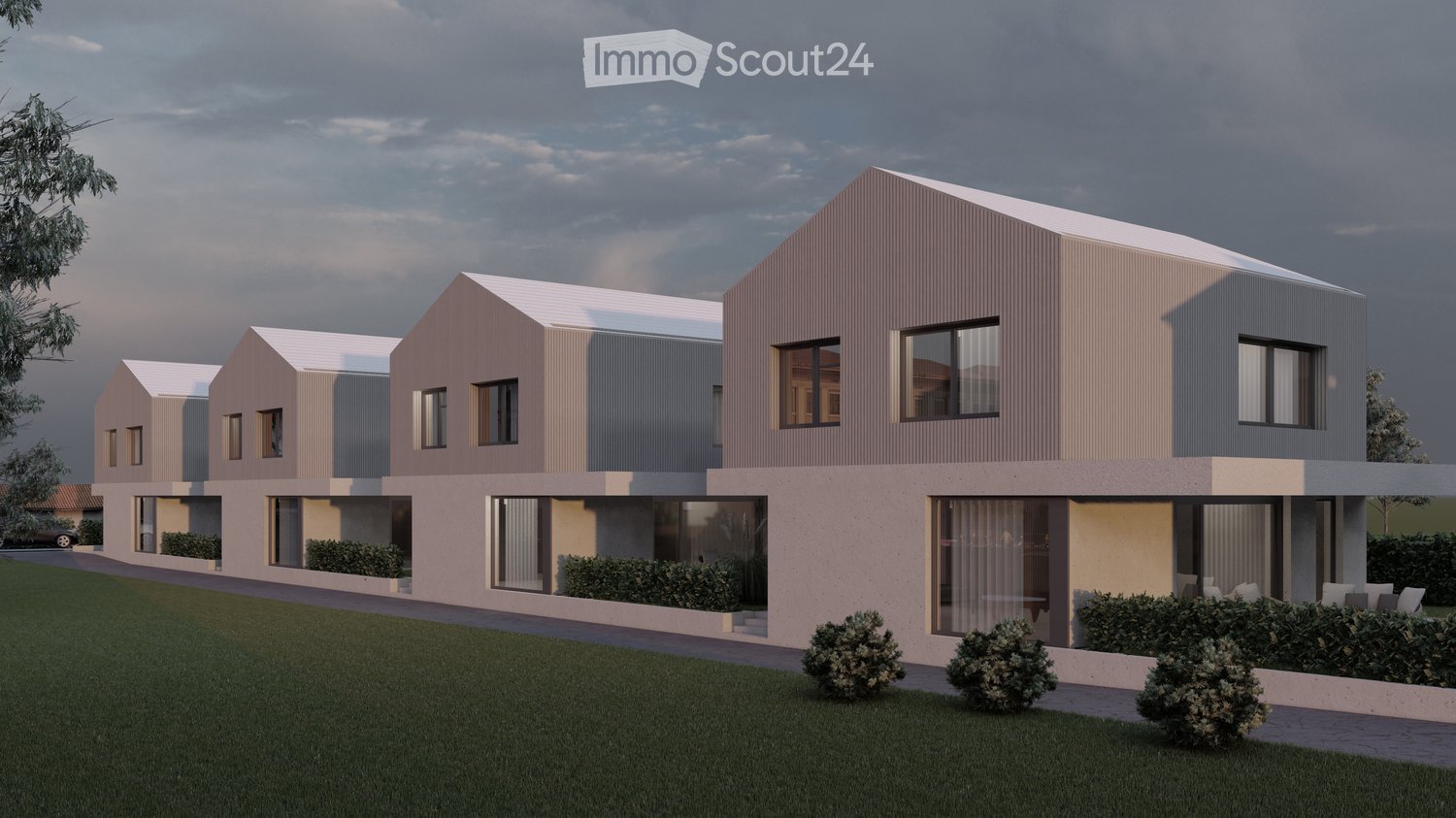 A multi-unit residential building with a modern, minimalist design. The building features a series of connected units with gabled roofs, large windows, and a neutral color palette of beige and gray. The exterior is composed of a combination of stucco and