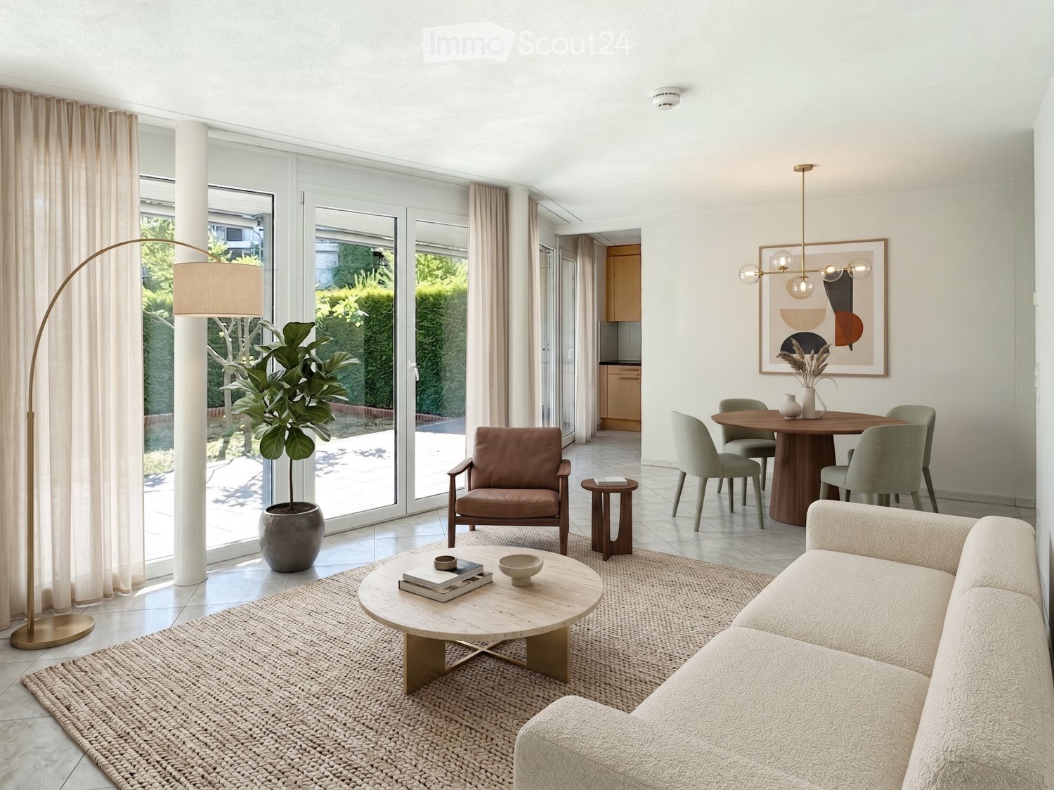 Modern living room with large windows, a beige sofa, a round coffee table, a leather armchair, a floor lamp, and a dining area with a round table and chairs.