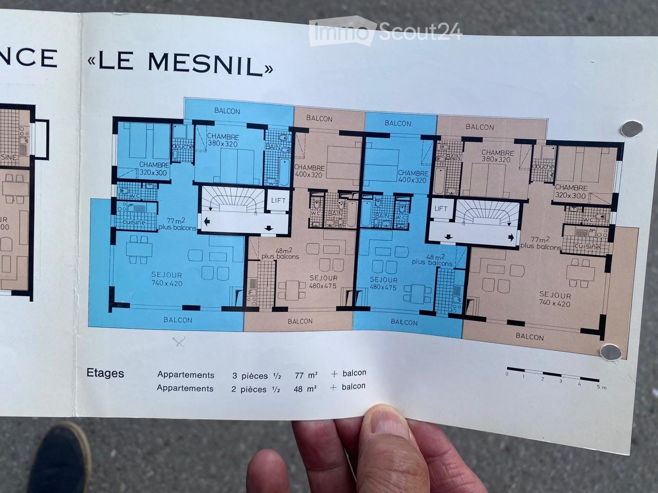 Floor plan of "LE MESNIL" showing multiple apartments with living rooms, bedrooms, bathrooms, balconies, and kitchens.