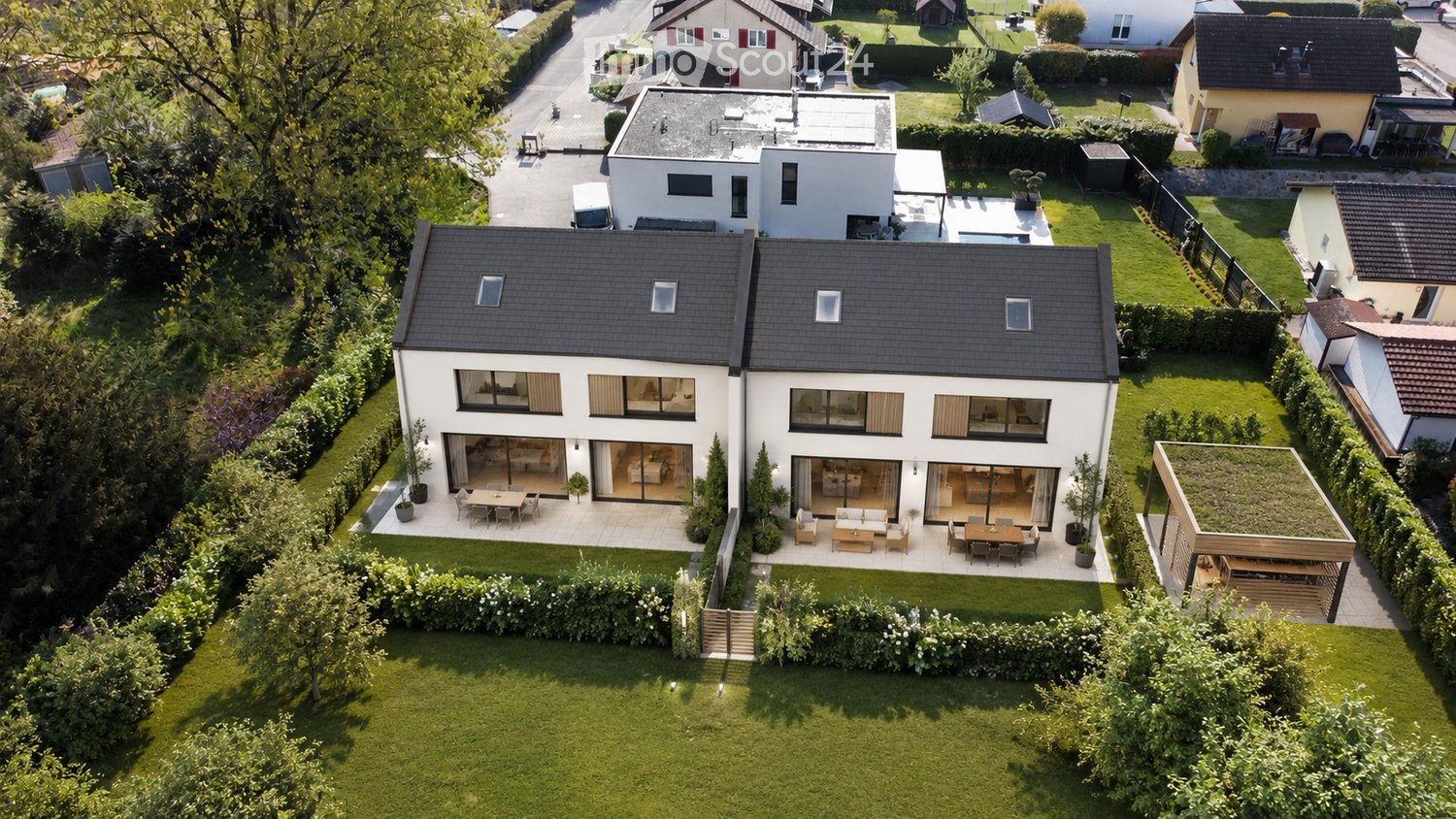 Modern two-story house with a flat roof, large windows, and a spacious garden with outdoor seating areas.