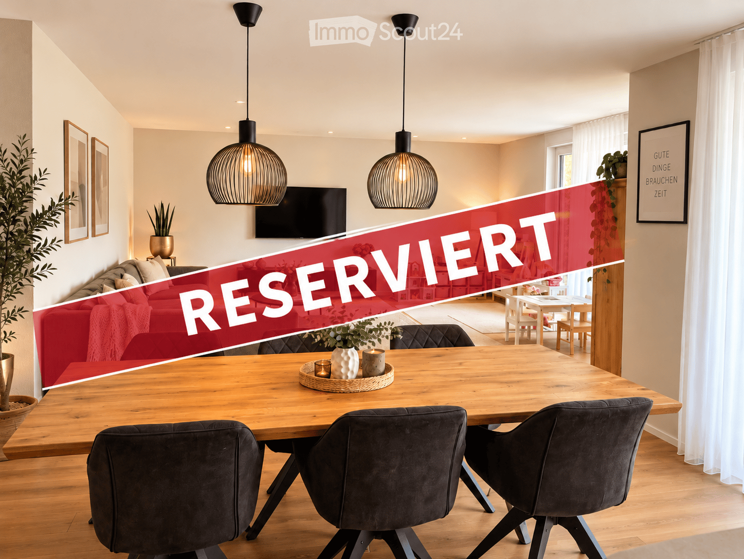 Modern living and dining area with a red sofa, wooden dining table, pendant lights, and a television mounted on the wall.