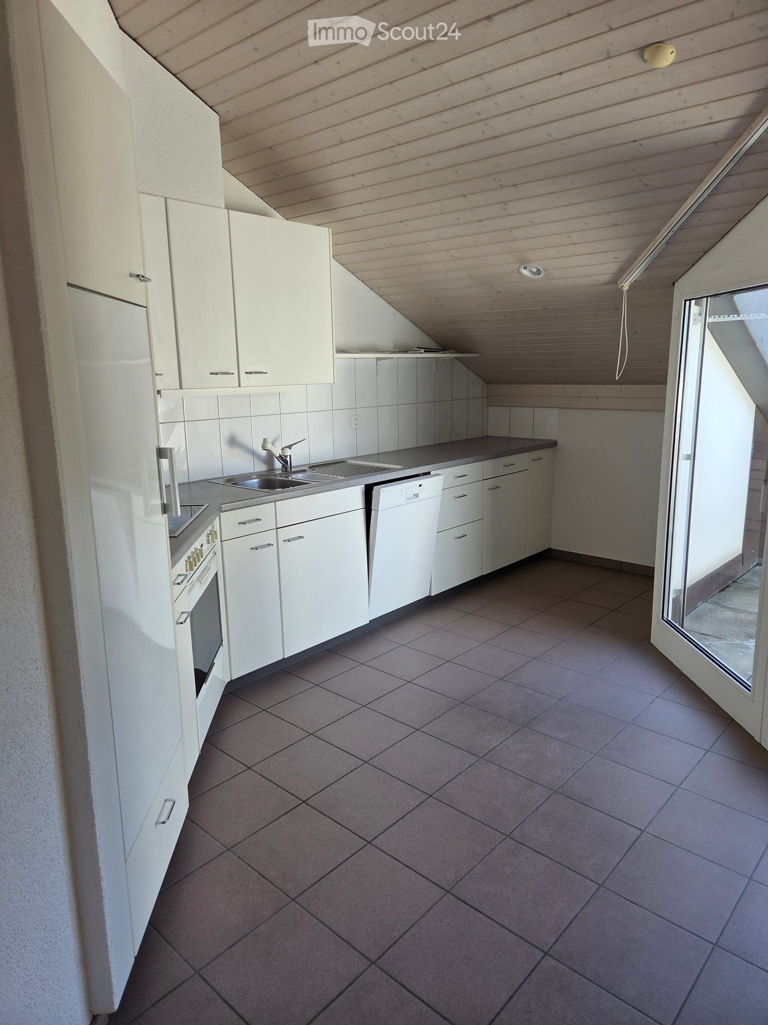 Modern kitchen with white cabinets, stainless steel appliances, and tiled flooring. Features an oven, refrigerator, sink, and dishwasher.