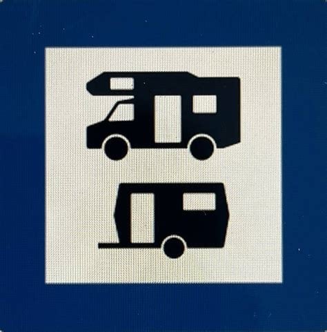 Sign indicating parking for caravans and motorhomes, with two caravan symbols.