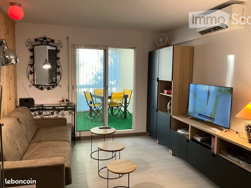 {"visible_features": ["Balcony / Terrace"], "type": "Living room", "description": "modern living room with a brown sofa, wooden tables, a flat screen TV, large windows with sliding doors leading to a terrace with outdoor furniture, wooden floor, white wal