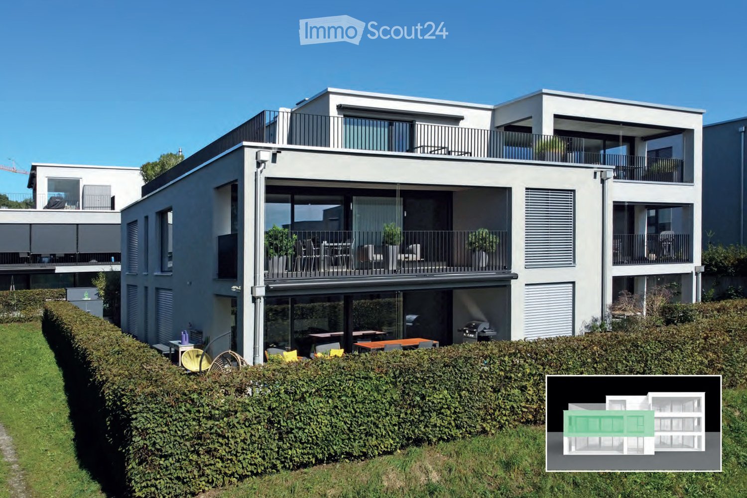 Modern multi-story house with a raised ground floor, two balconies, garden, and covered terrace.