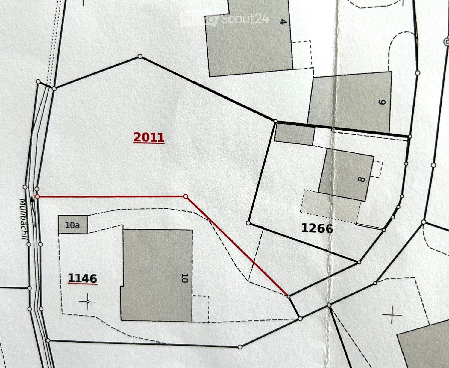 Floor plan showing multiple plots and structures with labeled sections and boundaries.