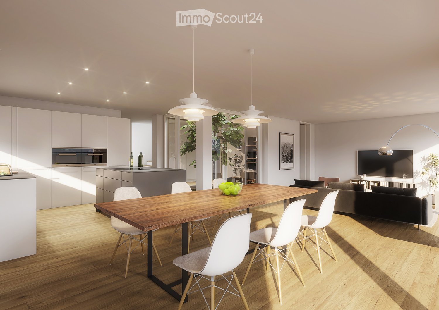Open-plan living and dining area with a wooden dining table, white chairs, a grey sofa, a television, pendant lights, and a modern kitchen with white cabinets and stainless steel appliances.