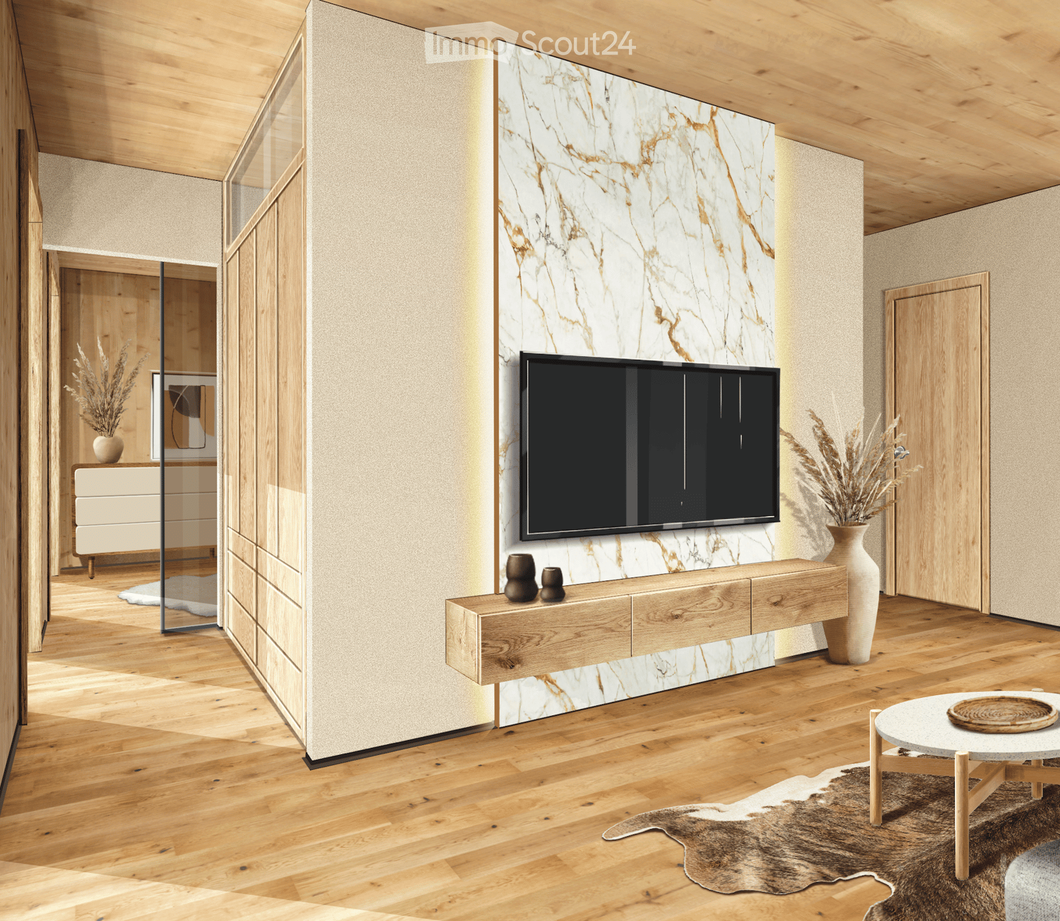Modern living room with wooden flooring, a large television mounted on a marble wall, a wooden cabinet, a vase with dried plants, and a small round table with a decorative tray.