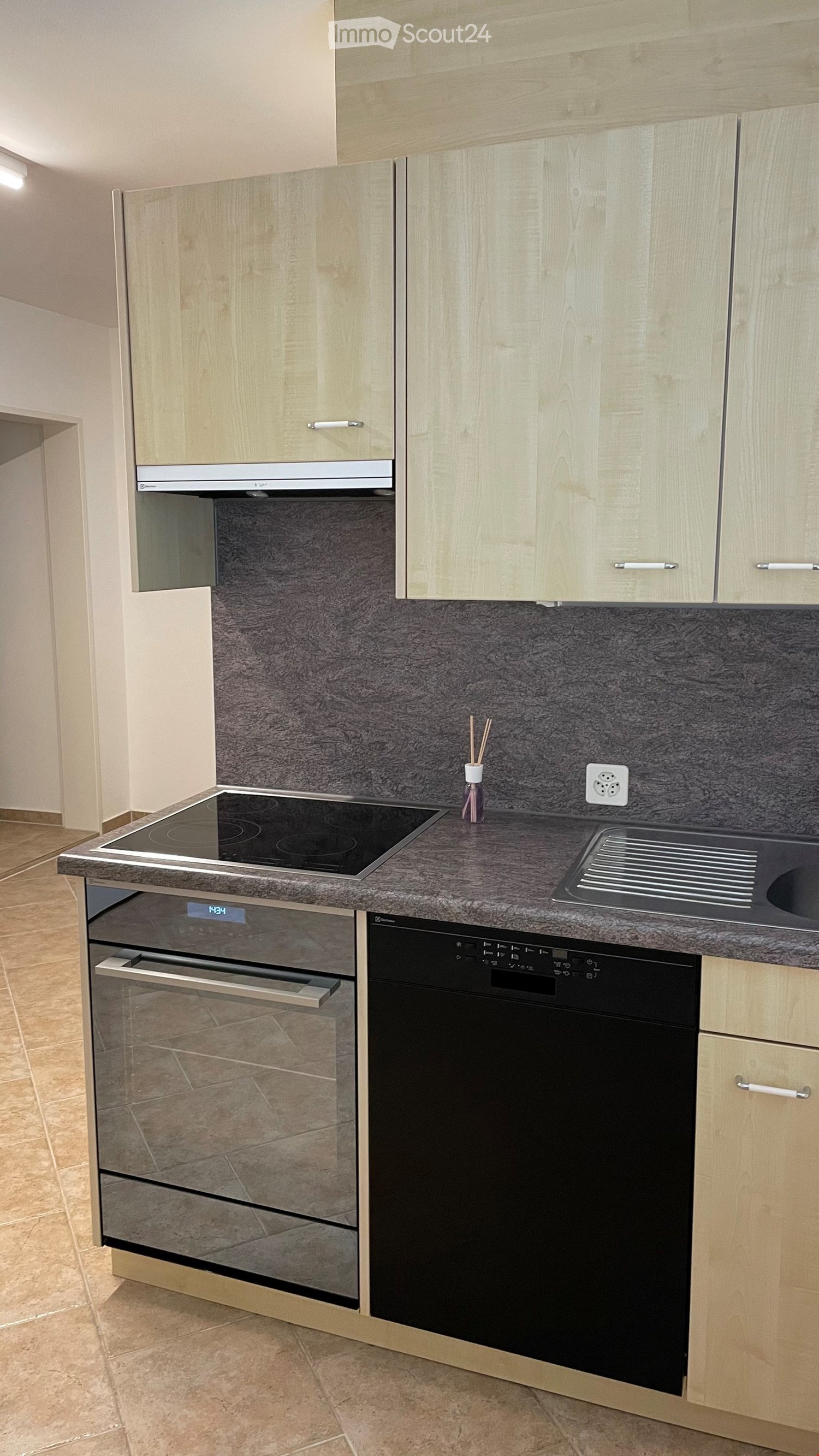 modern kitchen with induction stove, oven, dishwasher, granite countertop, wooden cabinets