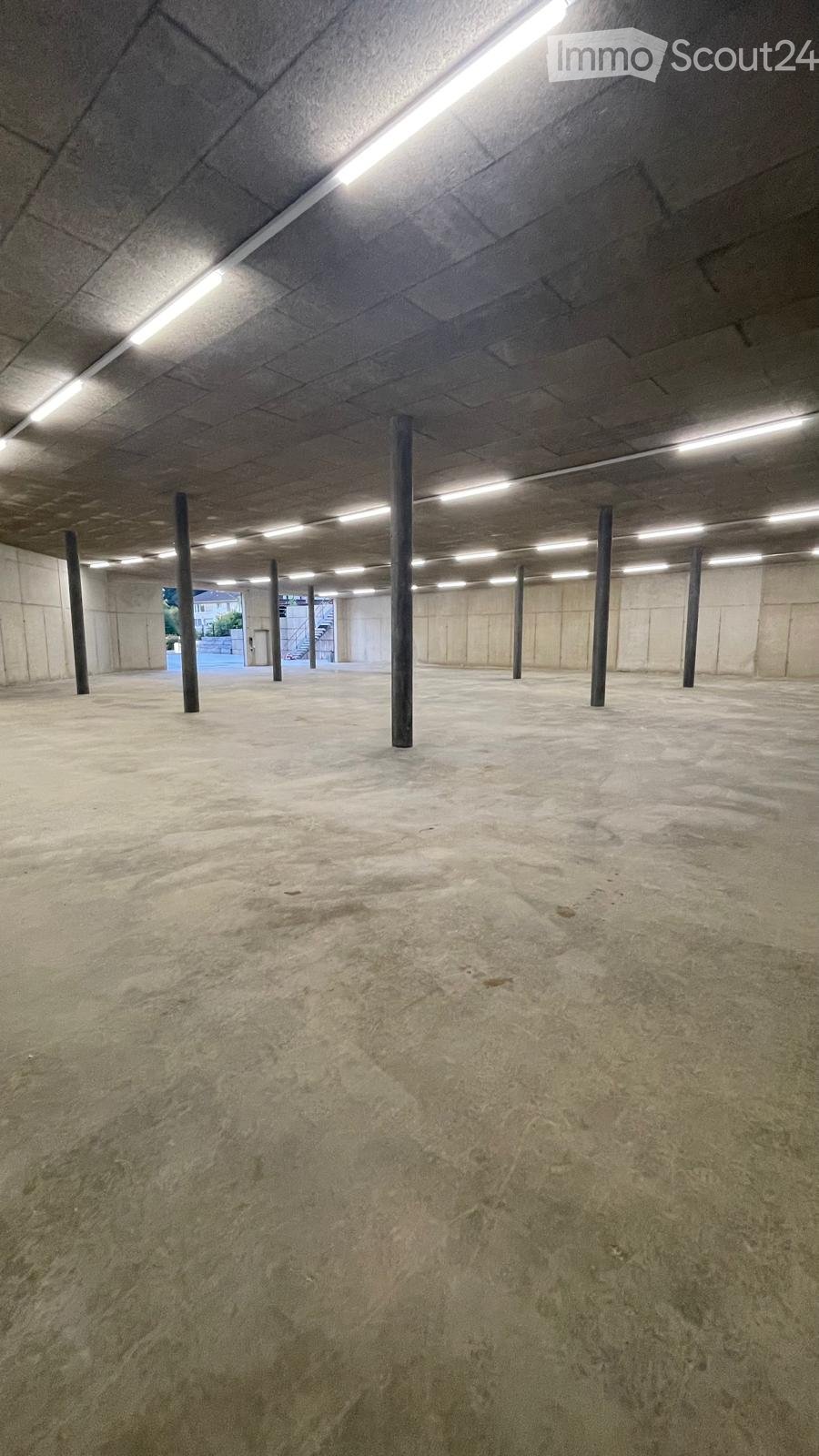 {"type": "Garage", "objects": [], "description": "Empty underground garage with concrete floors and pillars, fluorescent lighting, and a visible exit leading to the outside.", "localized_descriptions": {"EN": "Empty underground garage with concrete floors