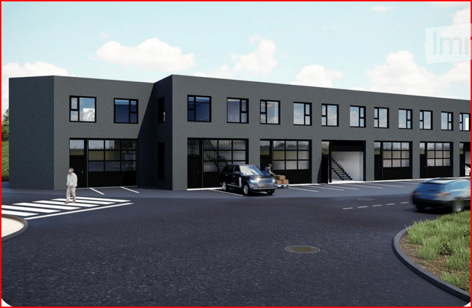 Modern industrial-style building with large garage doors, multiple windows, and a paved parking area.