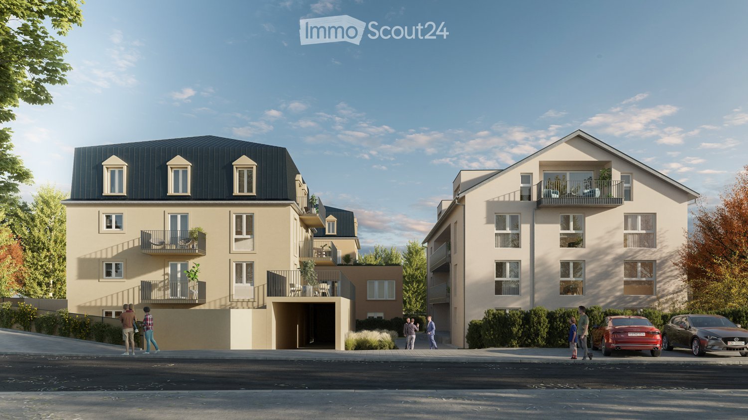 Modern two-story residential building with multiple balconies, large windows, and a flat roof. The building features a contemporary design with beige and dark gray exterior walls. There are several parked cars in front of the building, and a few people ar