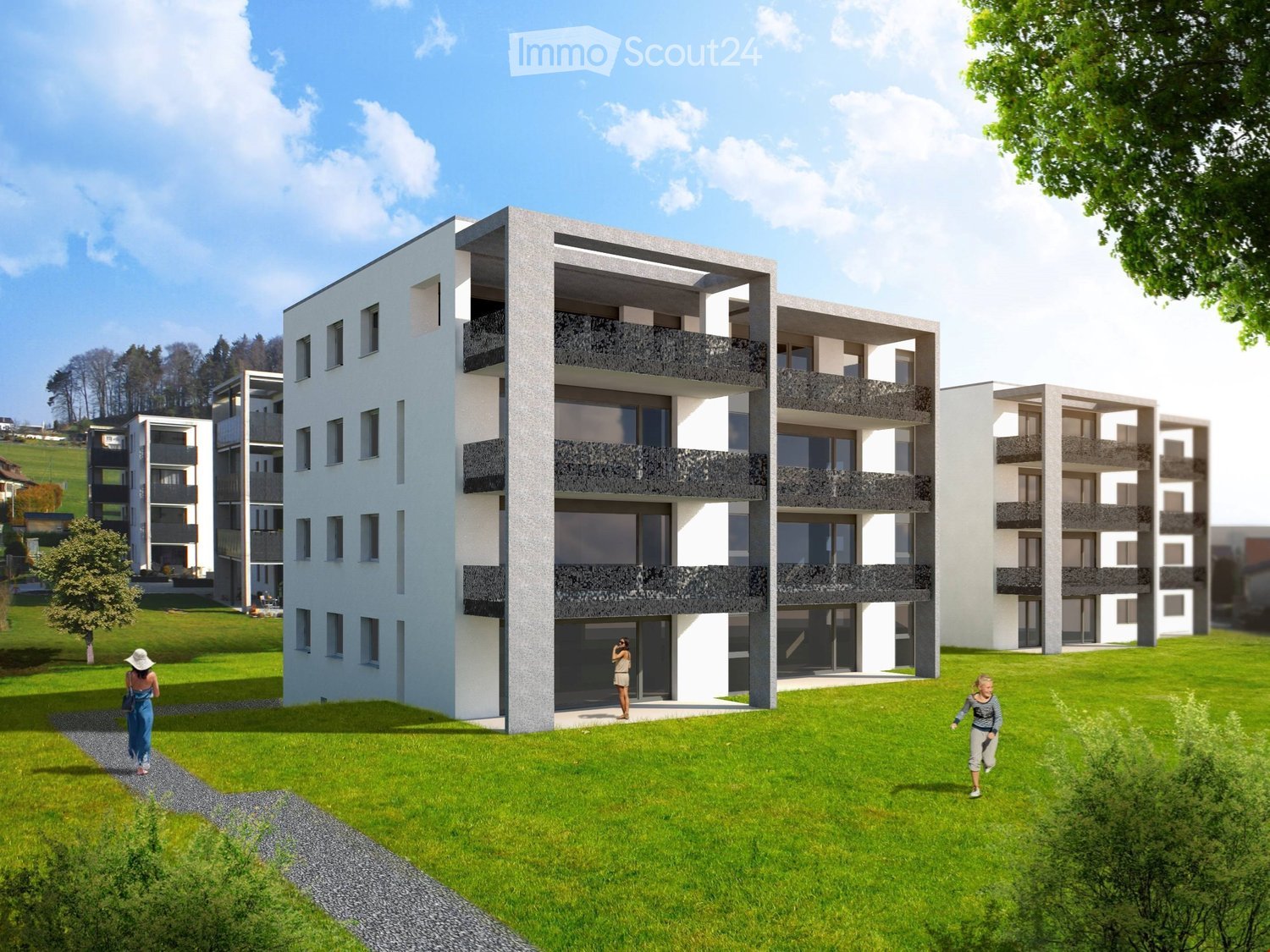 Modern multi-story residential building with balconies, surrounded by green lawn and trees.