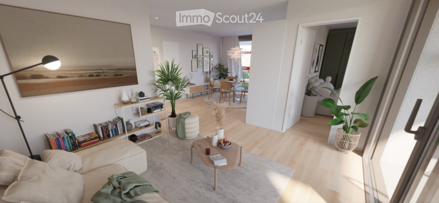 Modern living room with a sofa, coffee table, bookshelf, floor lamp, and a small dining area with a table and chairs. The space is decorated with plants, artwork, and books.
