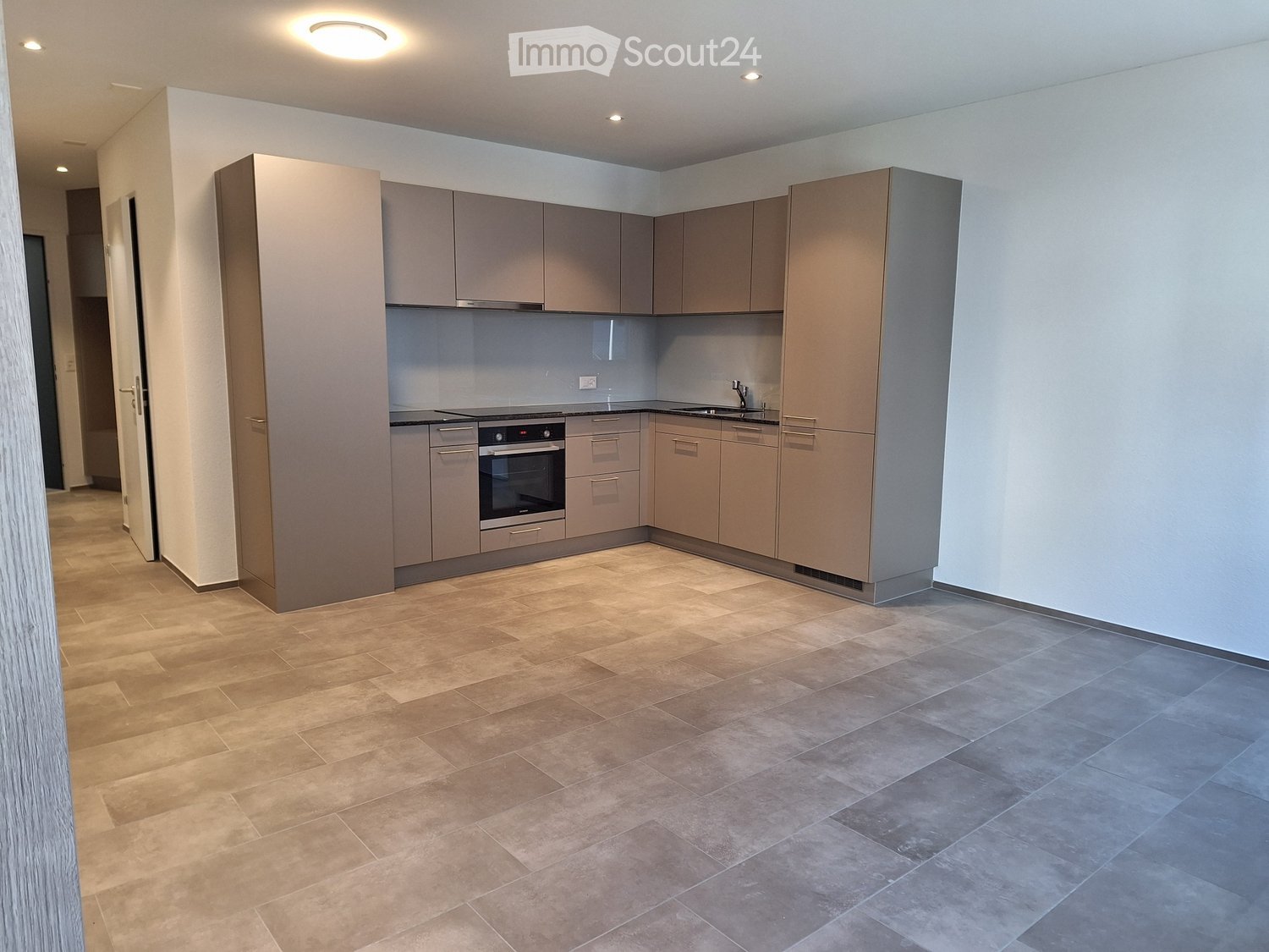 modern kitchen, grey cabinets, stainless steel appliances, tiled floor, gas stove, sink with faucet