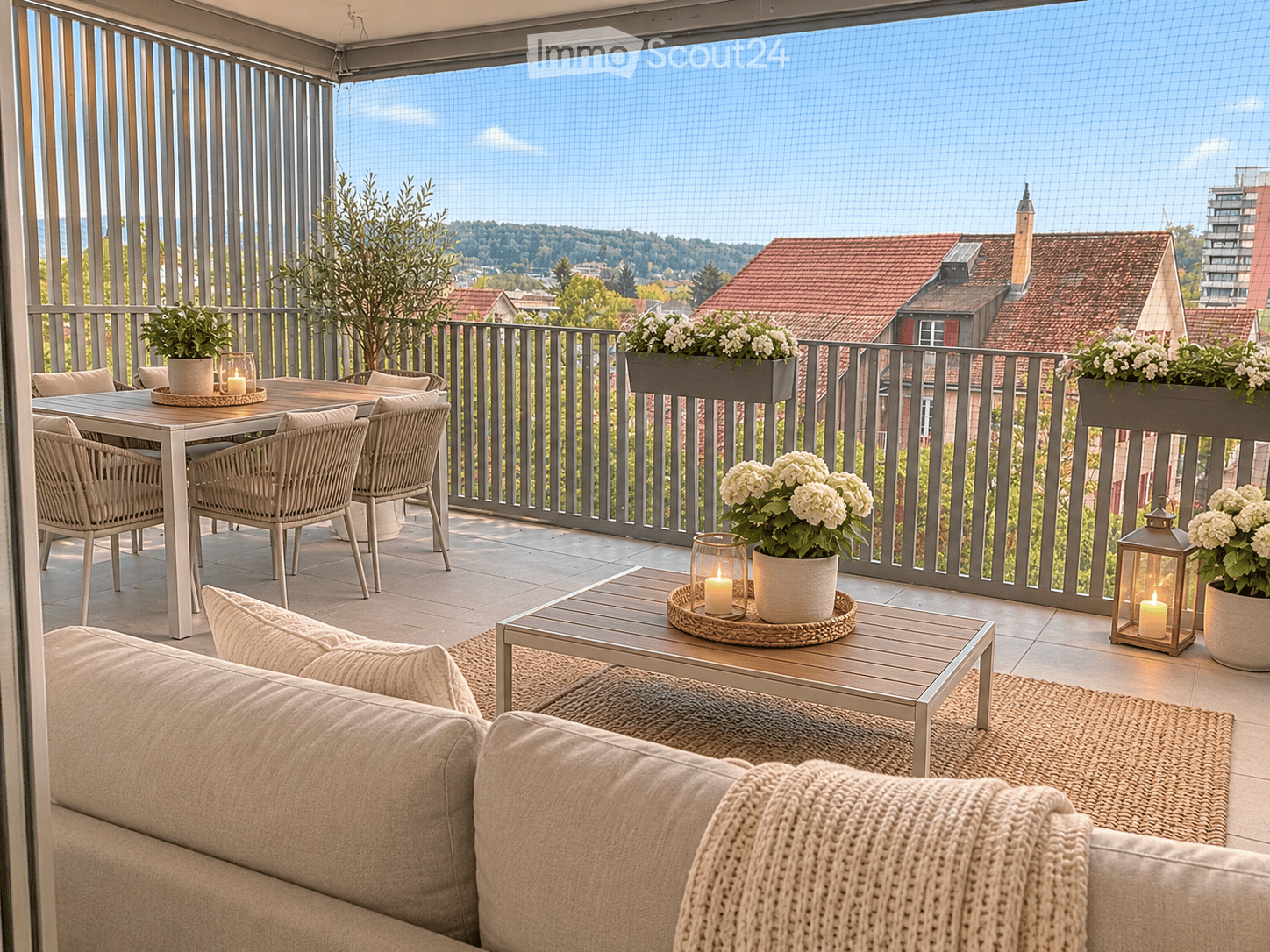 Balcony with a view, featuring a sofa, dining table with chairs, flower pots, and lanterns.