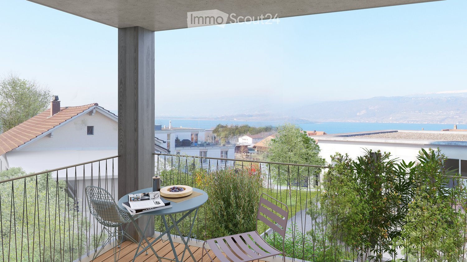 Balcony with a view of the sea, featuring a small round table, two chairs, and a bowl of fruit.