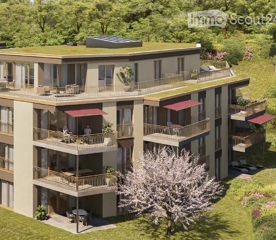 Modern multi-story residential building with balconies, terraces, and rooftop garden. Features large windows, contemporary design, and surrounding greenery.