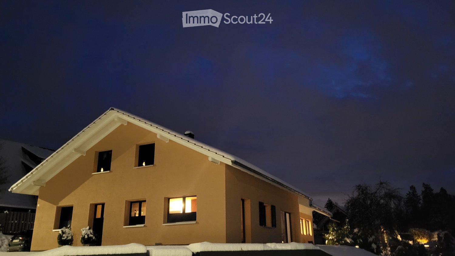 2 story house, beige walls, glass windows, slanted roof, snow, plants