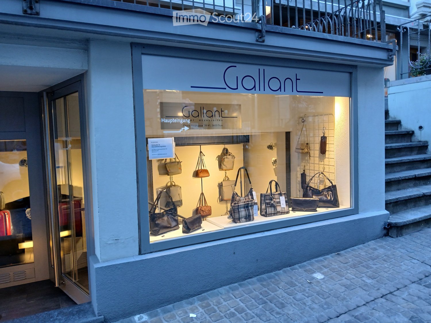 Storefront with large glass window displaying various handbags and accessories, sign reading "Gallant" above the entrance.