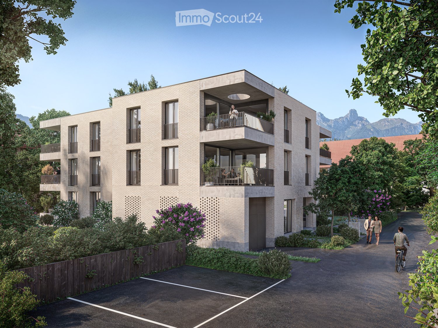 Modern multi-story residential building with balconies, surrounded by greenery and a scenic mountain view in the background.