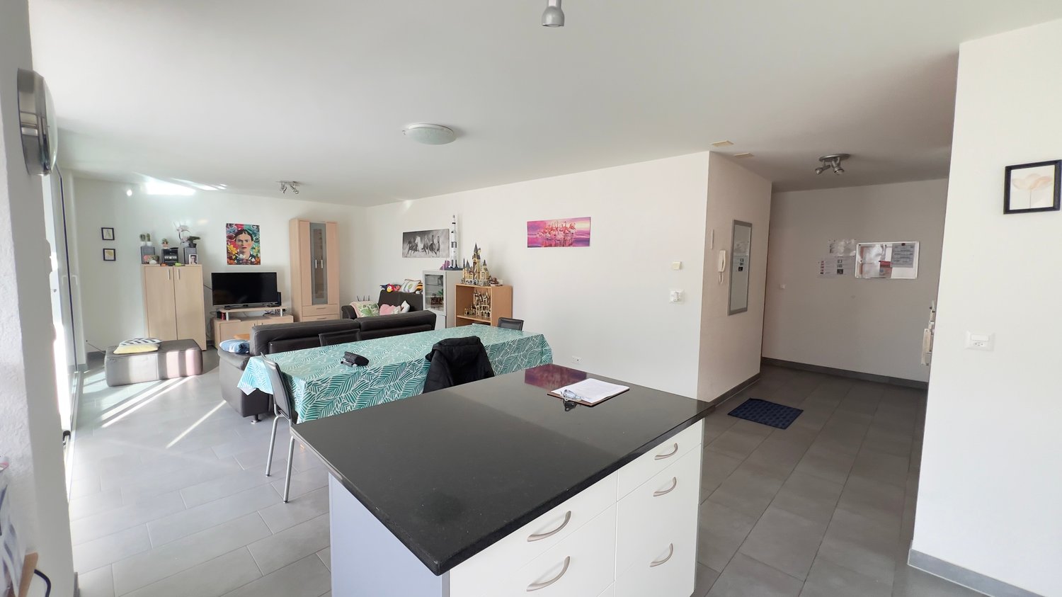 Modern interior design, dining table, sofa, television, cabinets, counter, kitchen drawers