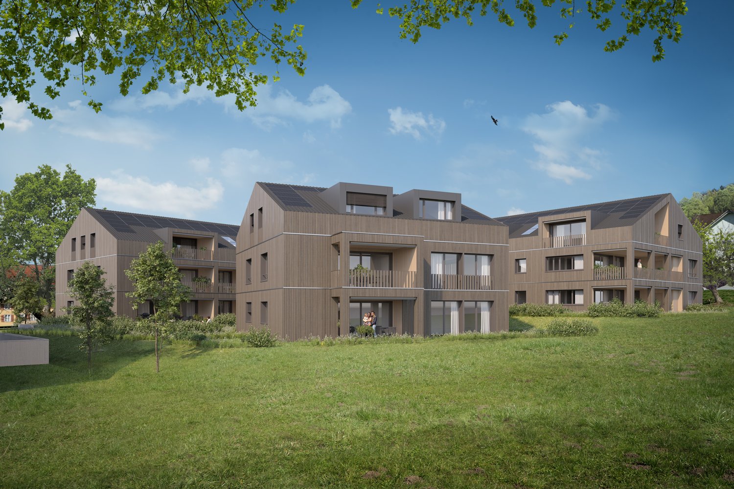 large building with multiple floors and balconies, solar panels on the roof, set in a grassy area