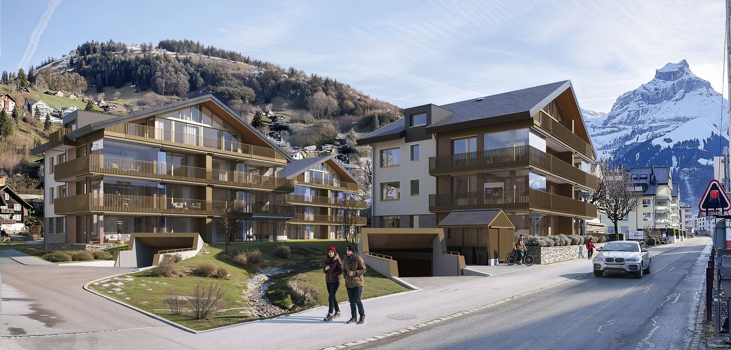 Modern multi-story buildings with balconies and terraces, raised ground floor entrance