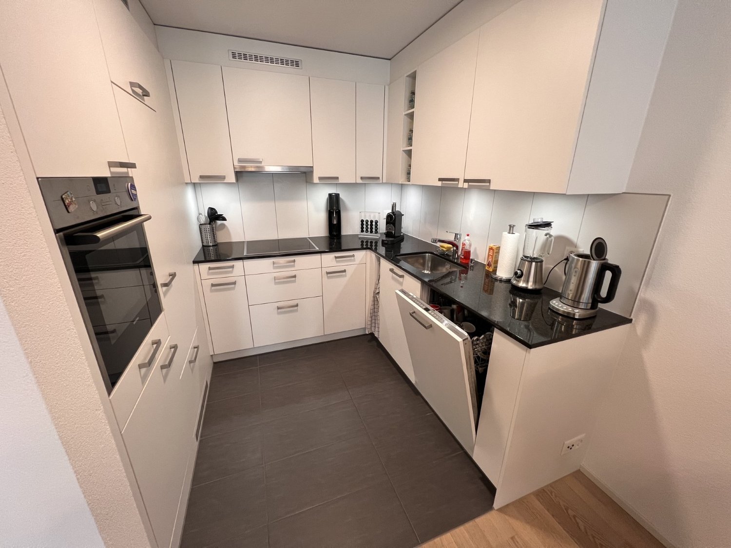 modern white kitchen with dishwasher, modern white kitchen with dishwasher, black countertop, white cabinets, modern appliances