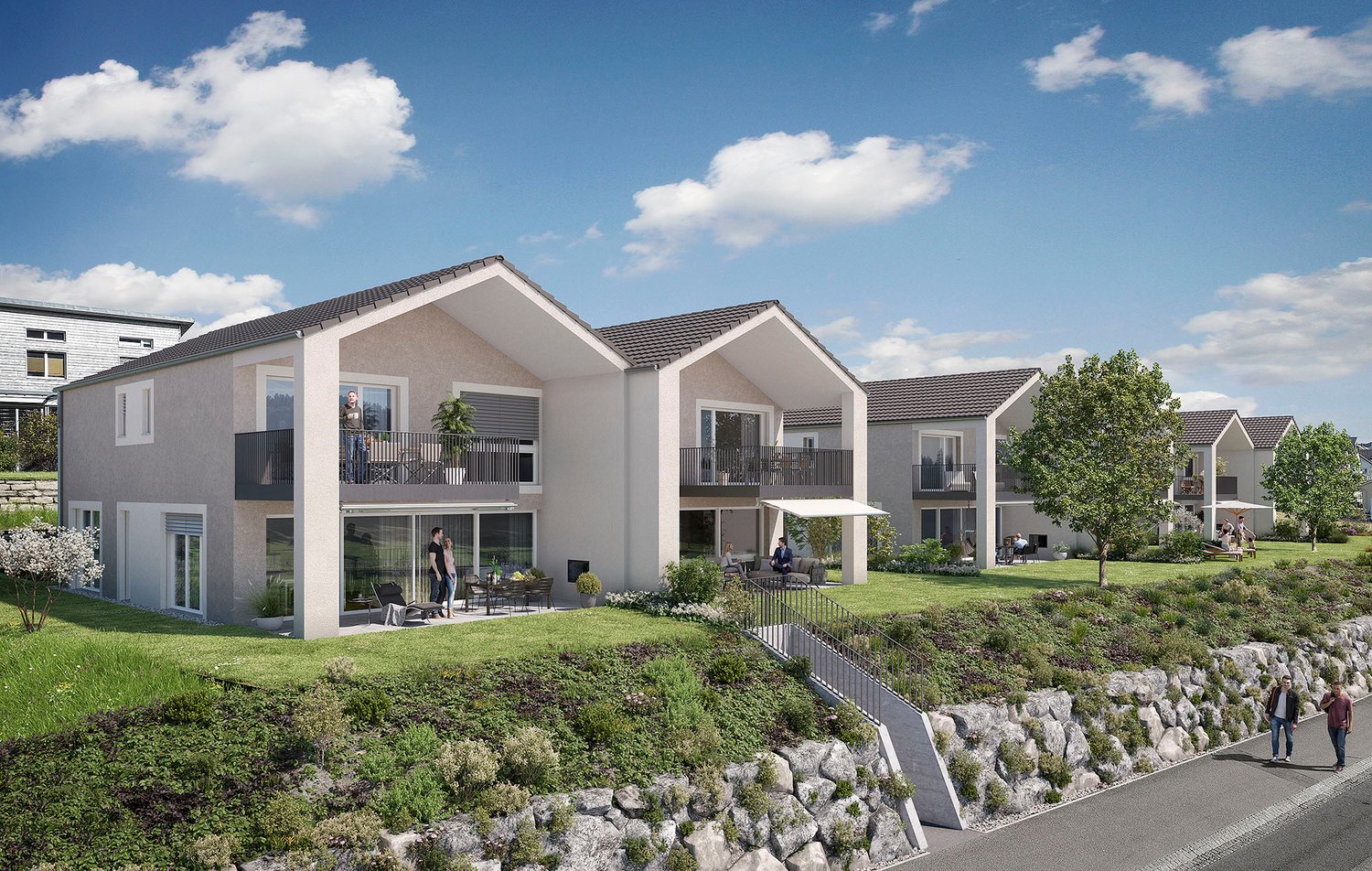 A row of new houses with modern architecture, each with balconies and two stories, set in a well-maintained landscaped area, featuring trees, lawns, and decorative shrubs.