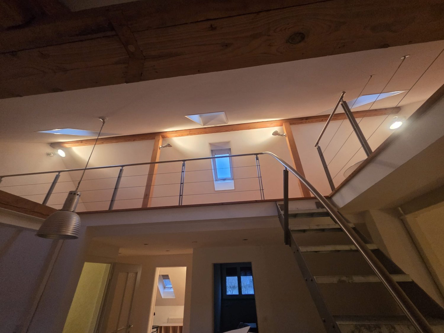 wooden ceiling, raised ground floor, railings, multiple windows