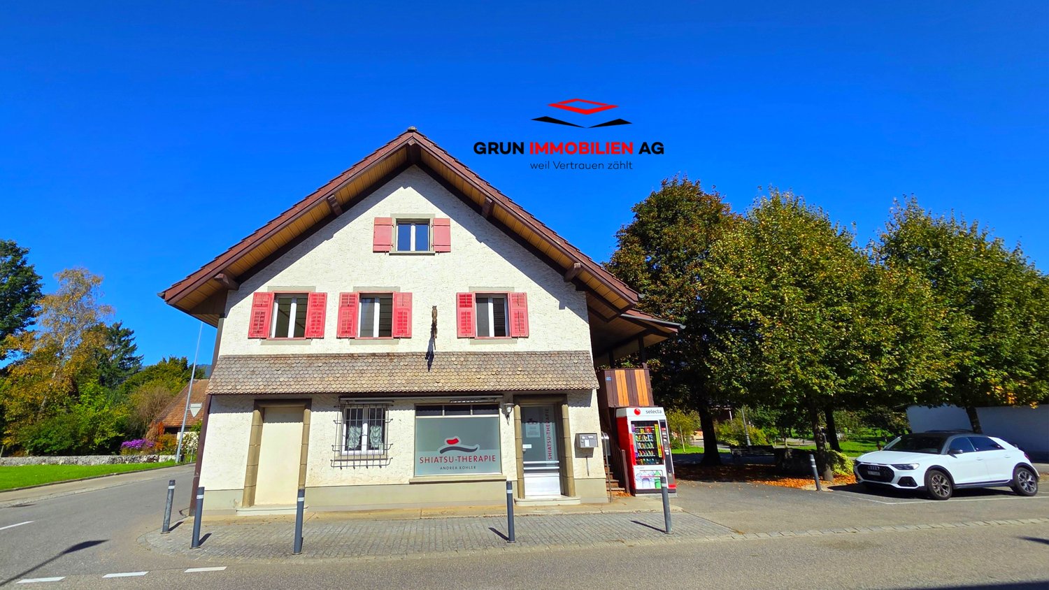 2 story building with garage, glass doors, red shutters, glass windows