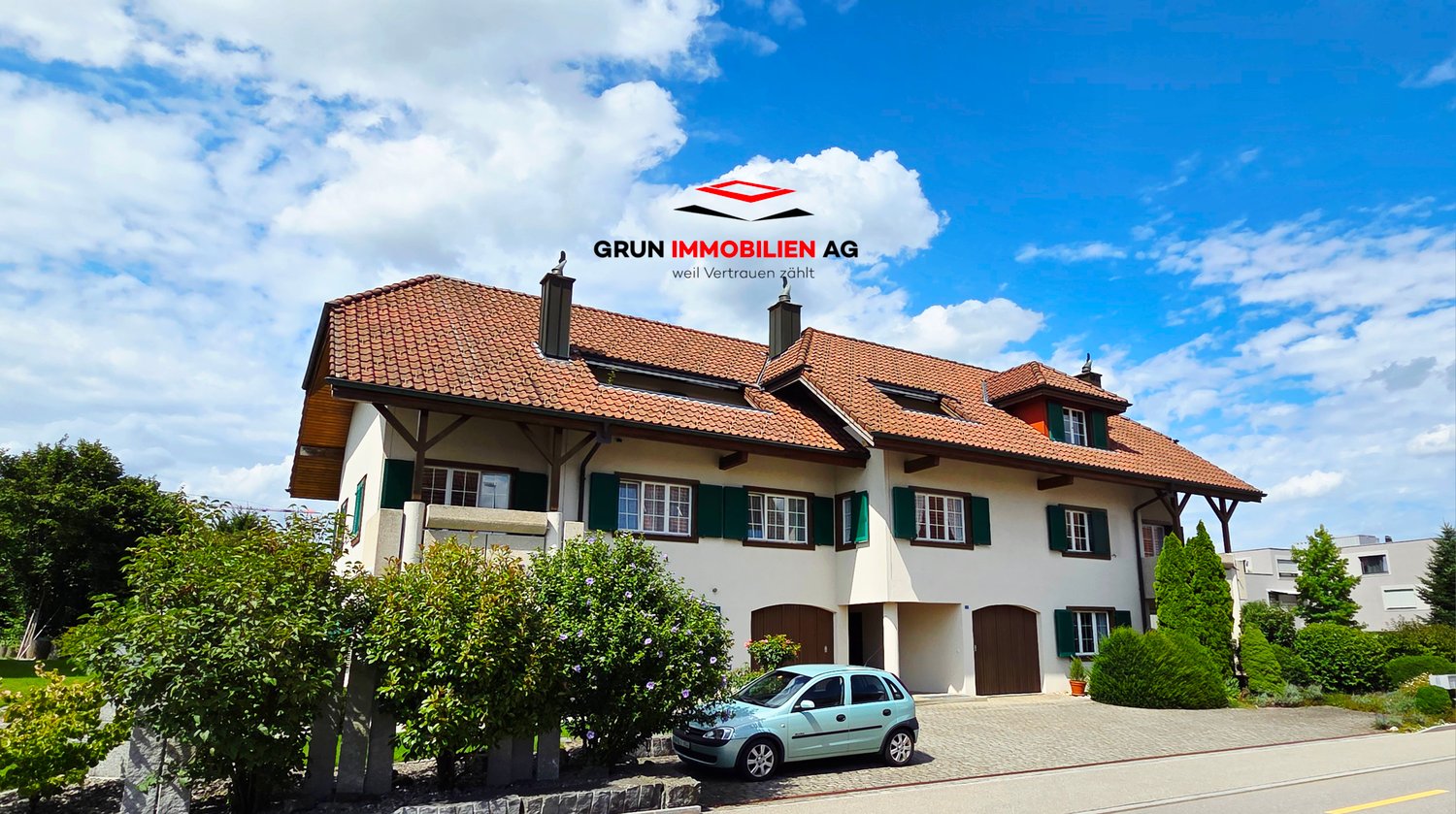 2 story house, red roof, white walls, green shutters, 2 garages, small garden in front