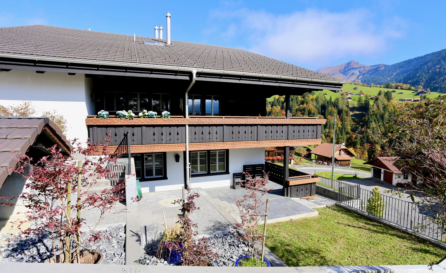 3 story house, balcony, garden, gravel path, scenic mountain view