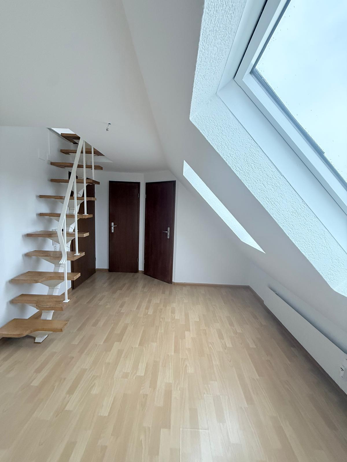 empty room, wooden staircase, two wooden doors, windows