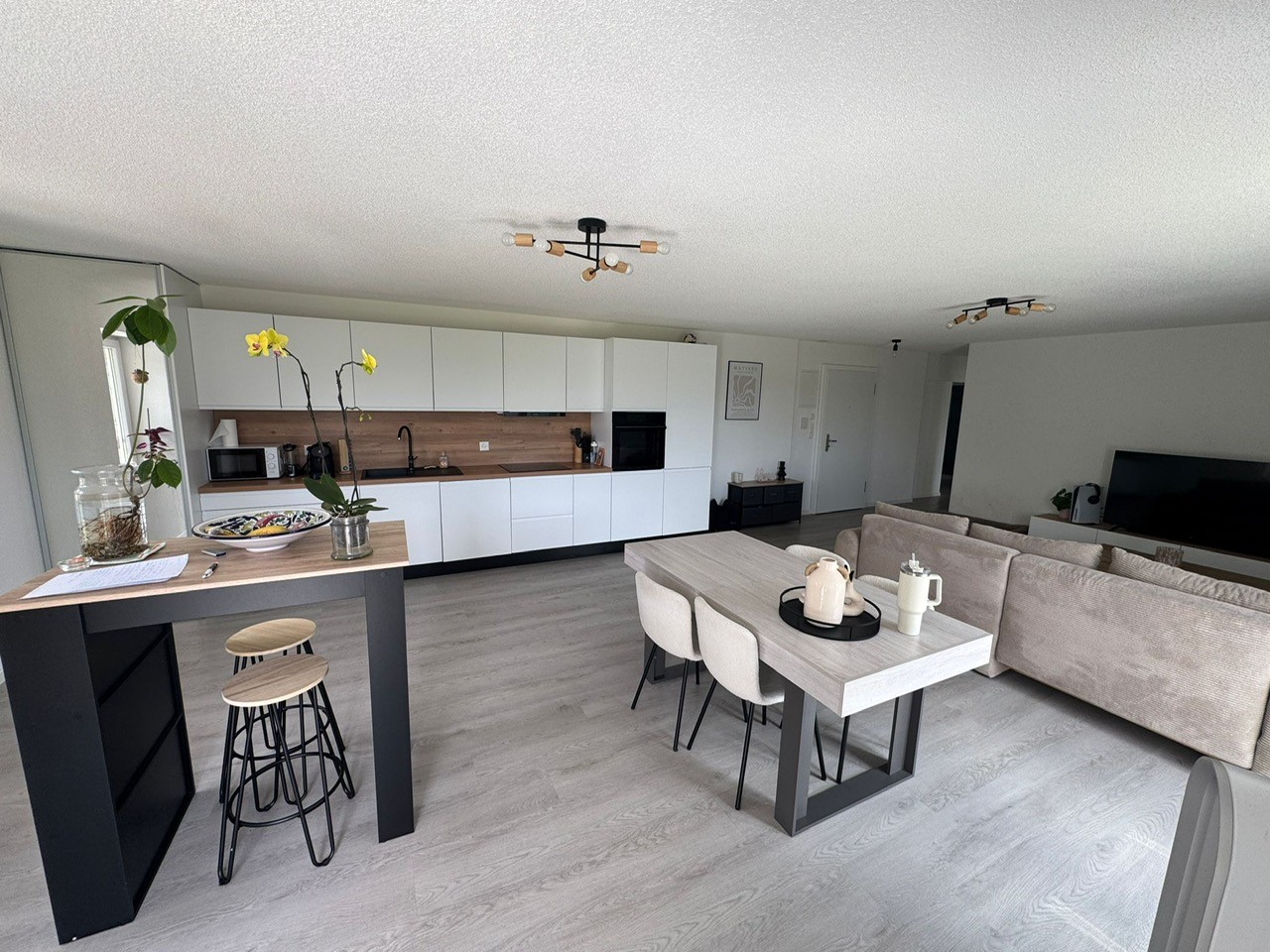 kitchen with dining table, couch, and TV