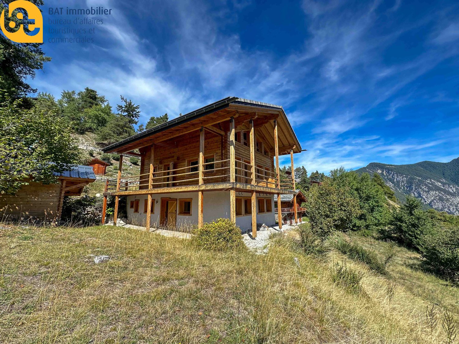 Wooden chalet with balcony, set in a mountainous area