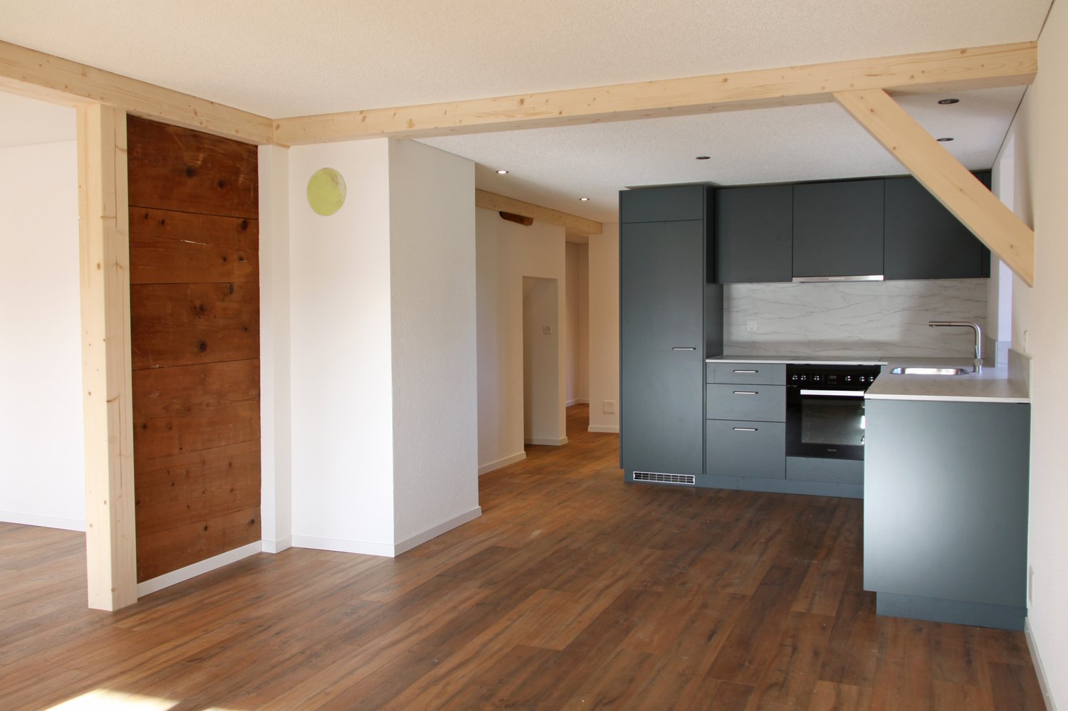 Empty room with kitchen area