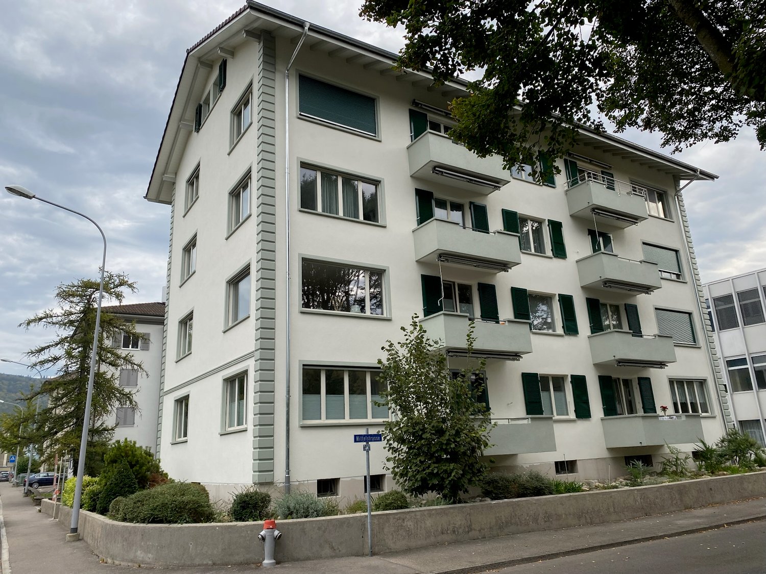White multistory apartment building with balconies