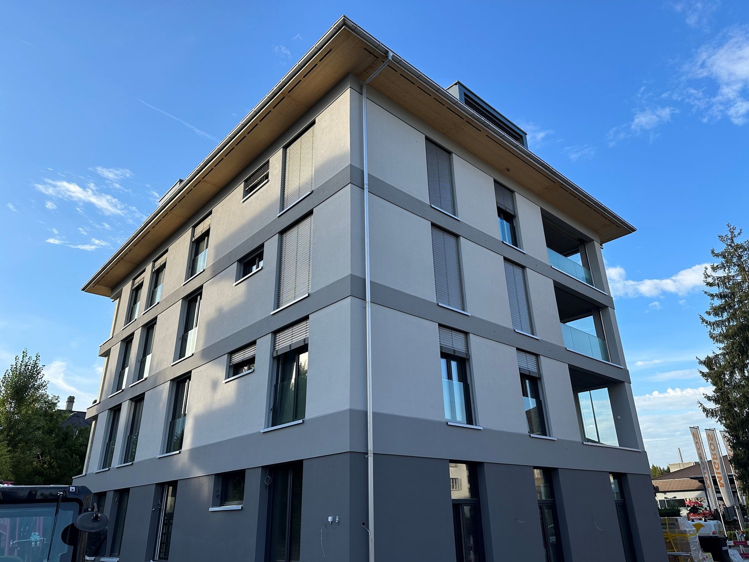 modern apartment building, gray facade, several windows, modern architecture