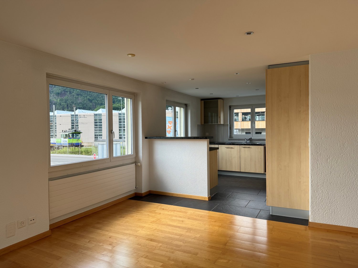 empty room with large windows and view of the outside