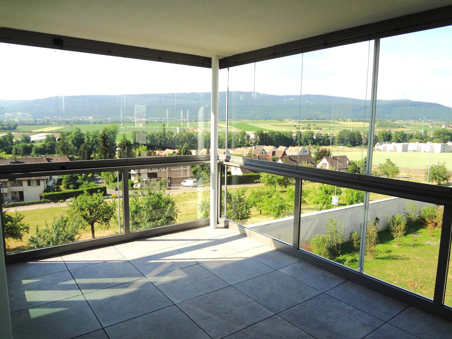 floored balcony, large windows, scenic views of valley