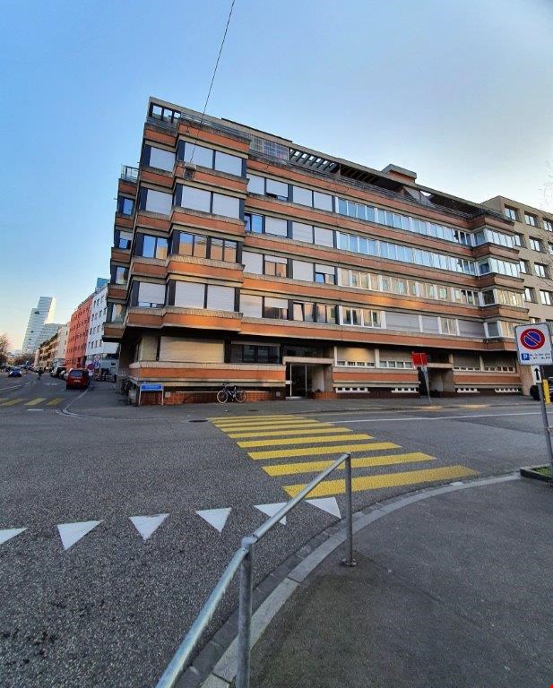multistory building, brick facade, multiple windows, bicycle parked outside