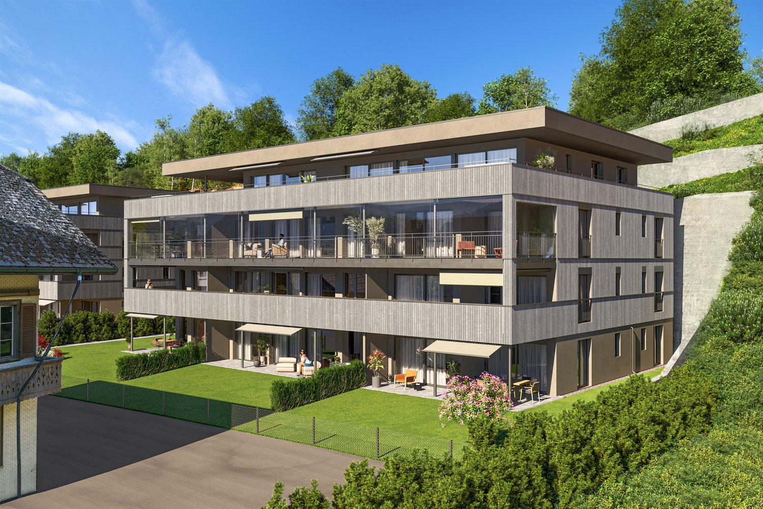 3-story modern apartment building with wooden siding, large windows, and balconies. The building is surrounded by lush greenery and has a paved parking area in the front.