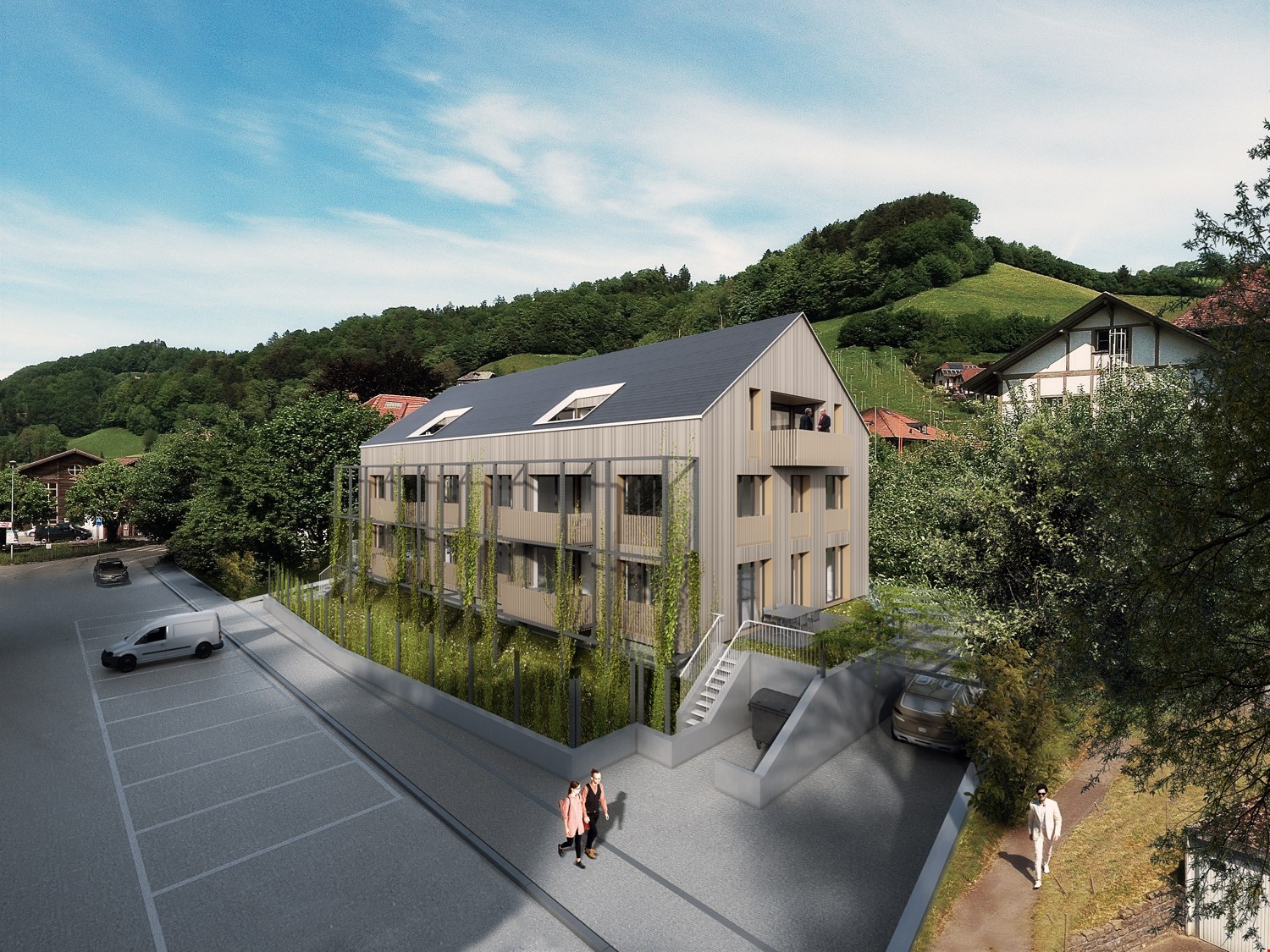 3-story apartment building with a modern, angular design and gray siding. The building has several balconies and is surrounded by greenery, including trees and a grassy area. There is a parking area in front of the building.