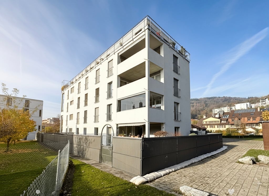 modern design white building, raised ground floor, multiple balconies
